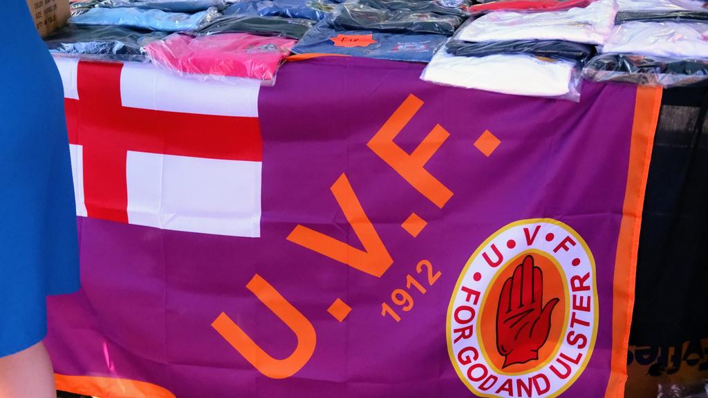 GAHargan's tweet photo. To confirm, the parachute regiment and UVF flags are for sale in a shared space today in Derry. 

£8 for the para flag. 
£10 for the UVF one.

Participants are free to walk around draped in flags of a regiment which killed innocent people in Derry and a paramilitary organisation. https://t.co/BFfsbLca6v