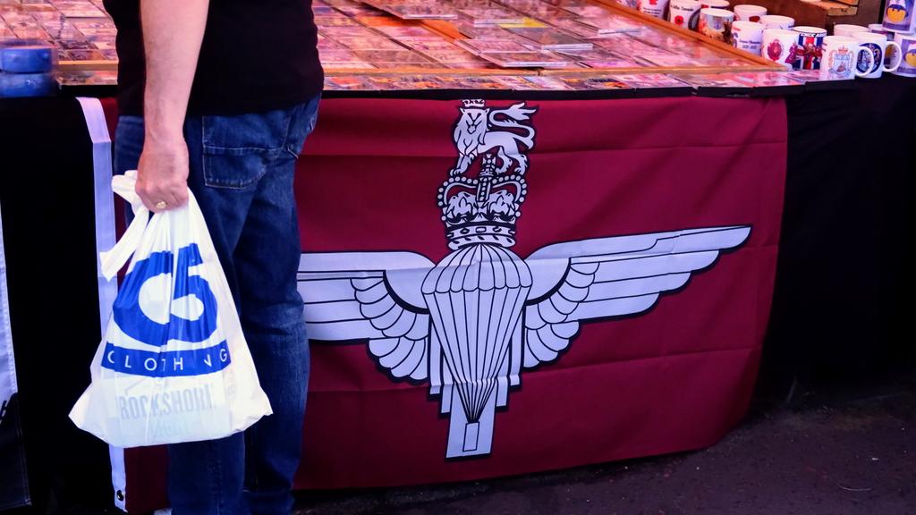 GAHargan's tweet photo. To confirm, the parachute regiment and UVF flags are for sale in a shared space today in Derry. 

£8 for the para flag. 
£10 for the UVF one.

Participants are free to walk around draped in flags of a regiment which killed innocent people in Derry and a paramilitary organisation. https://t.co/BFfsbLca6v