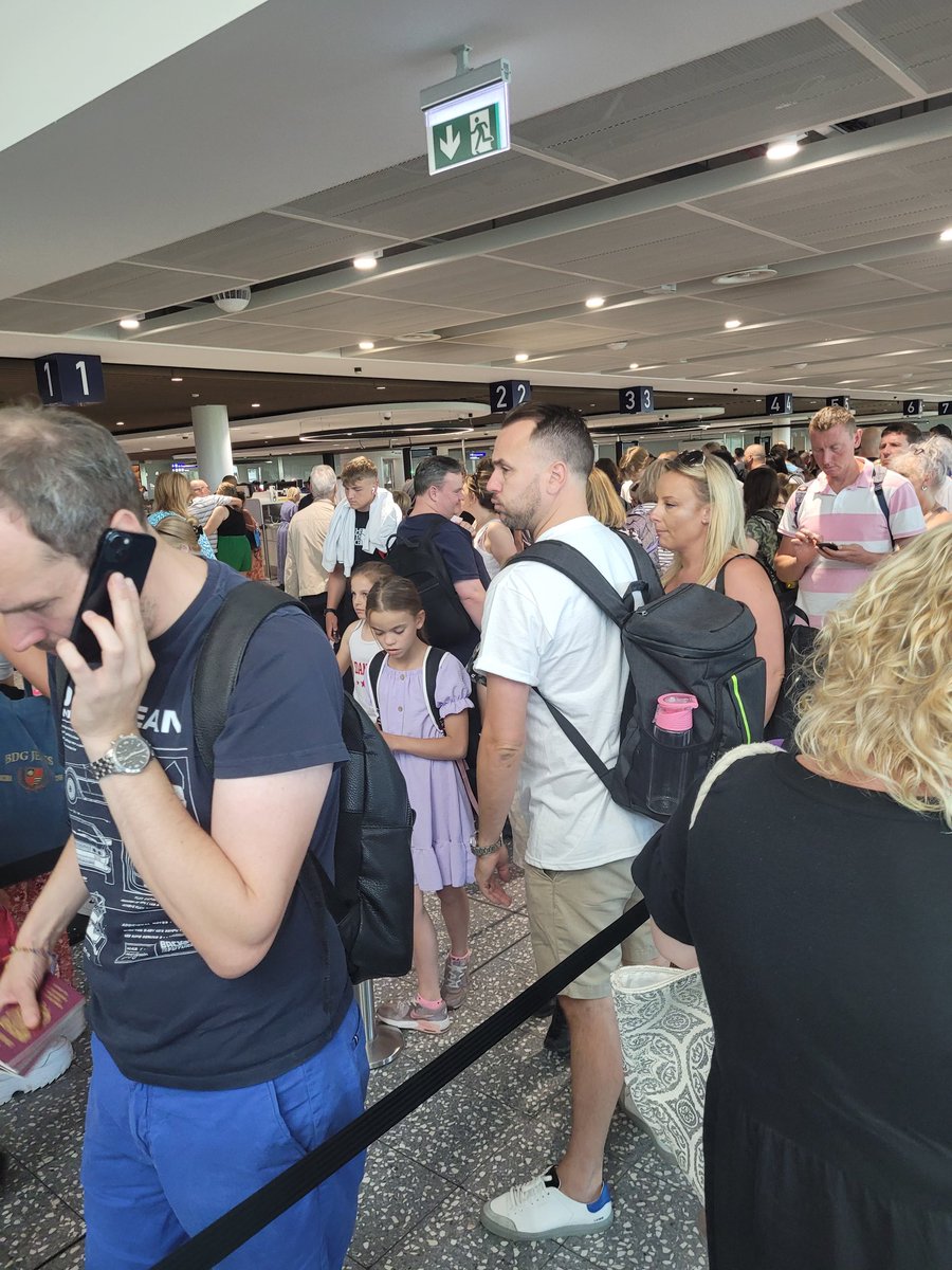 Chazzacon's tweet photo. @BristolAirport a 40 minute wait through fast track security. Now sitting on a @AerLingus plane waiting on a boiling plane no aircon to get bags on delays due to staff shortages. https://t.co/A2dAyrsRWw