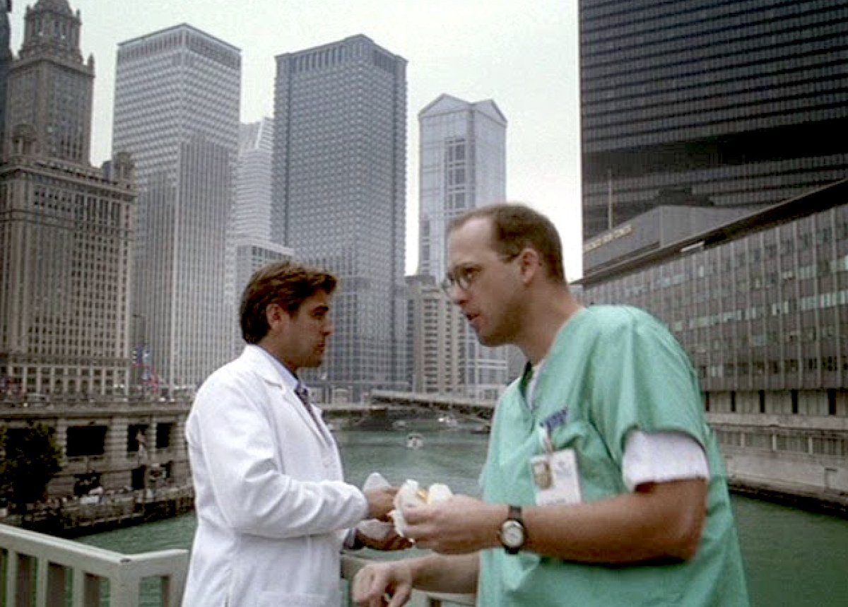 Classic 1990s Chicago: Dr. Doug Ross and Dr. Mark Greene take a lunch break on the Michigan Ave. Bridge, with the old <a href="/Suntimes/">Chicago Sun-Times</a> building in the background.