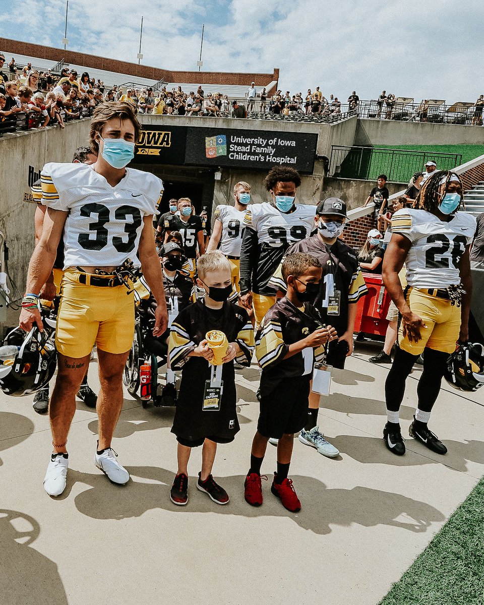 HawkeyeFootball's tweet photo. Swarming with our Kid Captains 💛

#Hawkeyes https://t.co/USOvsiUP3A