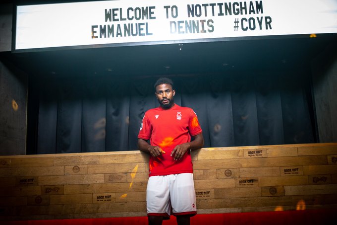 Emmanuel Dennis under a sign at Rock City stating 'Welcome to Nottingham Emmanuel Dennis #COYR.'