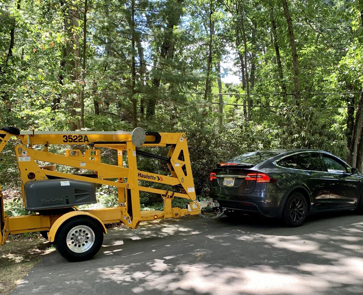 The spouse towing a 3,000-pound bucket lift. DIY house painting thanks to our #dirtytesla !