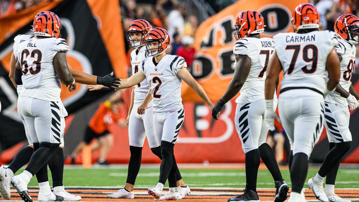 Players high-fiving Evan McPherson after kicking a field goal.