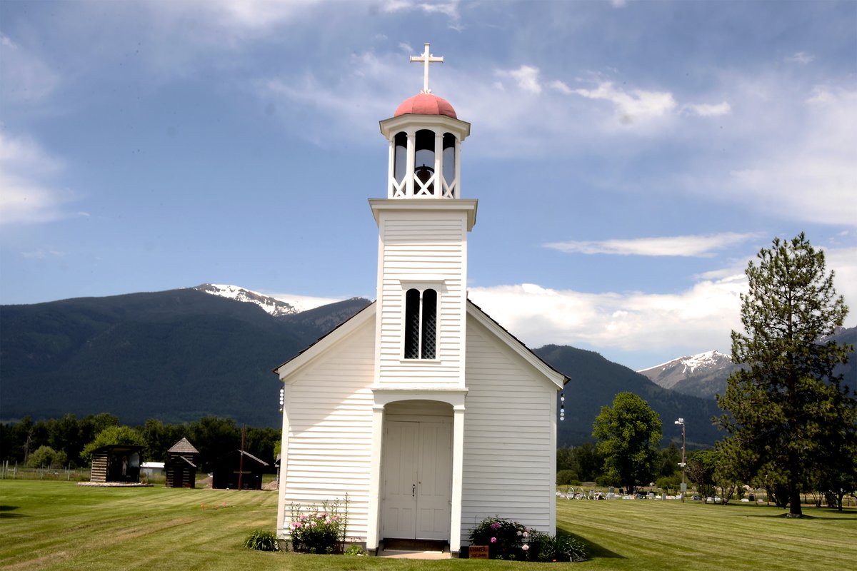 LandgrabPod's tweet photo. At the historic St. Mary's Mission in Stevensville, a stark contrast separates the headstones of the marked Christian graves and the unmarked plot of indigenous burials. https://t.co/WAWrfaBtVj