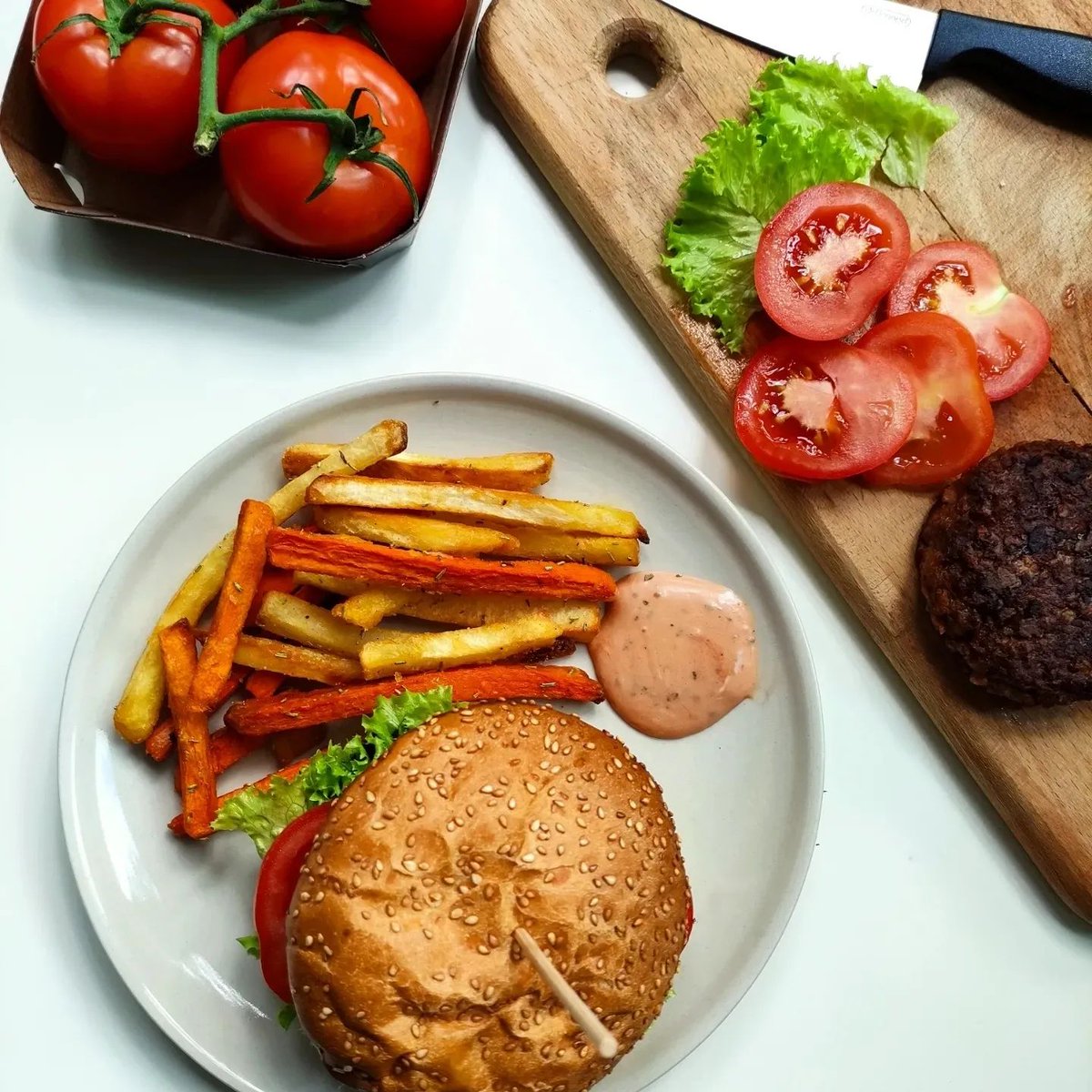 Soy burger and fried sweet potato with condiments.