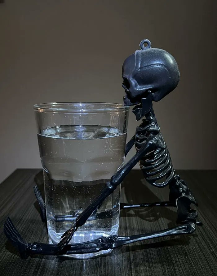 TMOS_ARC's tweet photo. Undying Thirst – A skeleton trying to drink water from a glass, that’s just a little below the brim, making it unable to drink #TMOSScienceWeek https://t.co/beuoEJn1hz