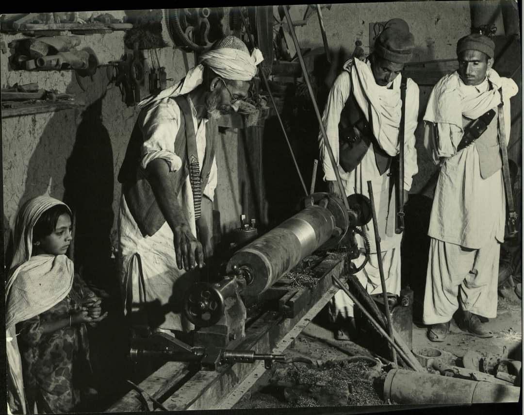 historyofAJK's tweet photo. A gunsmith of small arms factory in Jamrud making an artillery gun for the Kashmir War, December 1947. Photo by Margaret Bourke-White. https://t.co/9H7bPiy6pL