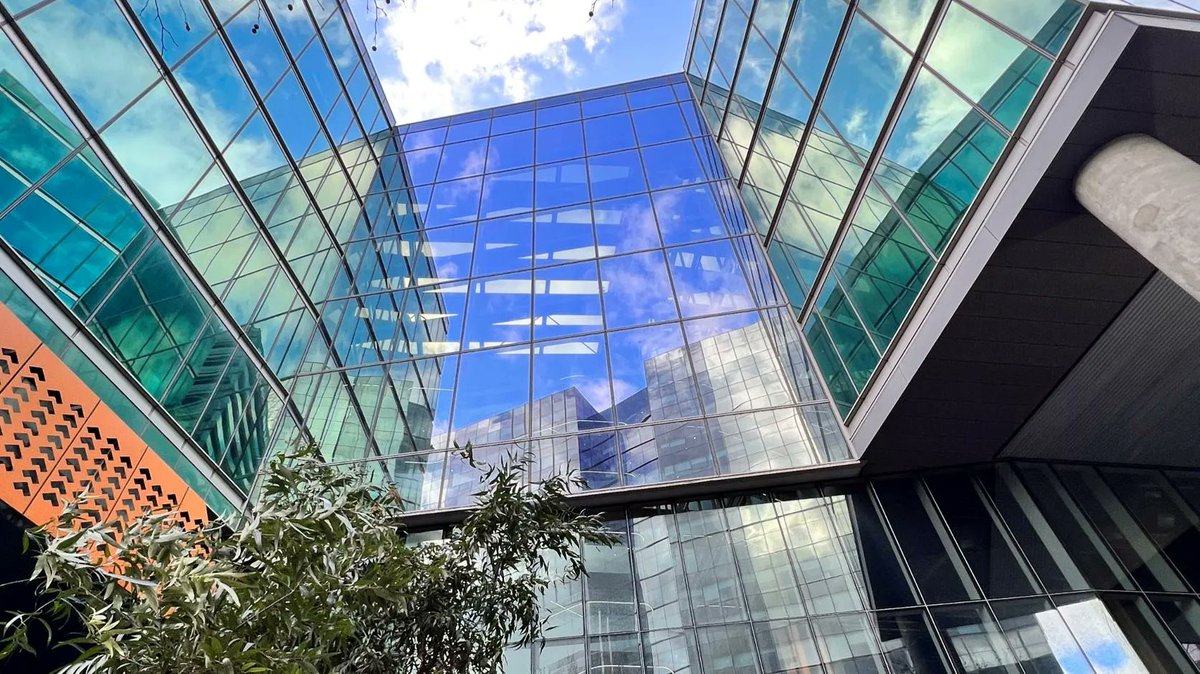 TMOS_ARC's tweet photo. Sombre Self – Reflection of buildings on the glass panels adorning the walls of this Monash University building on a clear day #TMOSScienceWeek https://t.co/D4ULoqCwz1