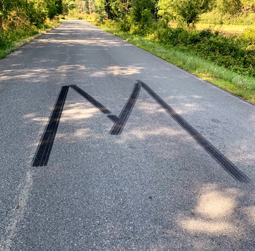 Artist: Unknown
Nationality: Likely American.
Title: M or W, W or M, 2022
Medium: Carbon black in butadiene/polybutadiene amalgam applied with breaking traction technique. 

A temporary installation by a regional outsider artist. Note the use of multiple "brushstrokes."