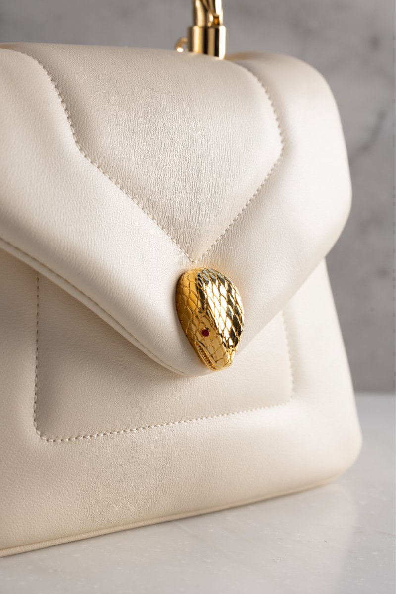 Bulgariofficial's tweet photo. Crafting beautiful summer accessories requires masterful skill. Artisans create this captivating #Bulgari #Serpenti Reverse bag by combining the craft of alluring textures with this swooping handle. https://t.co/z4EDqQGw7B #BulgariAccessories #Craftmanship #MadeInEden #FW22 https://t.co/6hf1TmA4Rt
