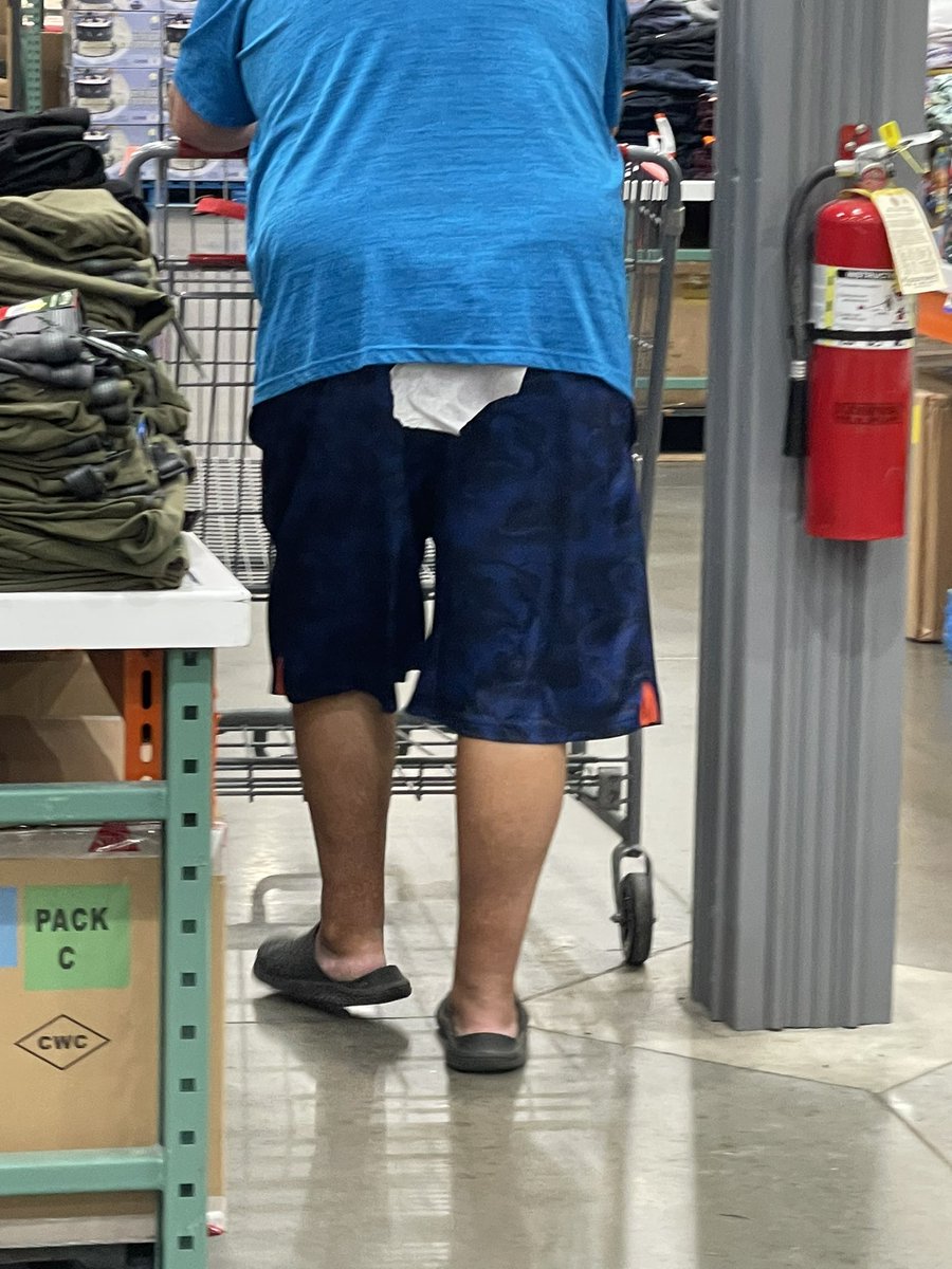 1.  Would you tell the person they have this going on?

2. Would you want someone to tell you this was hanging out of your pants?