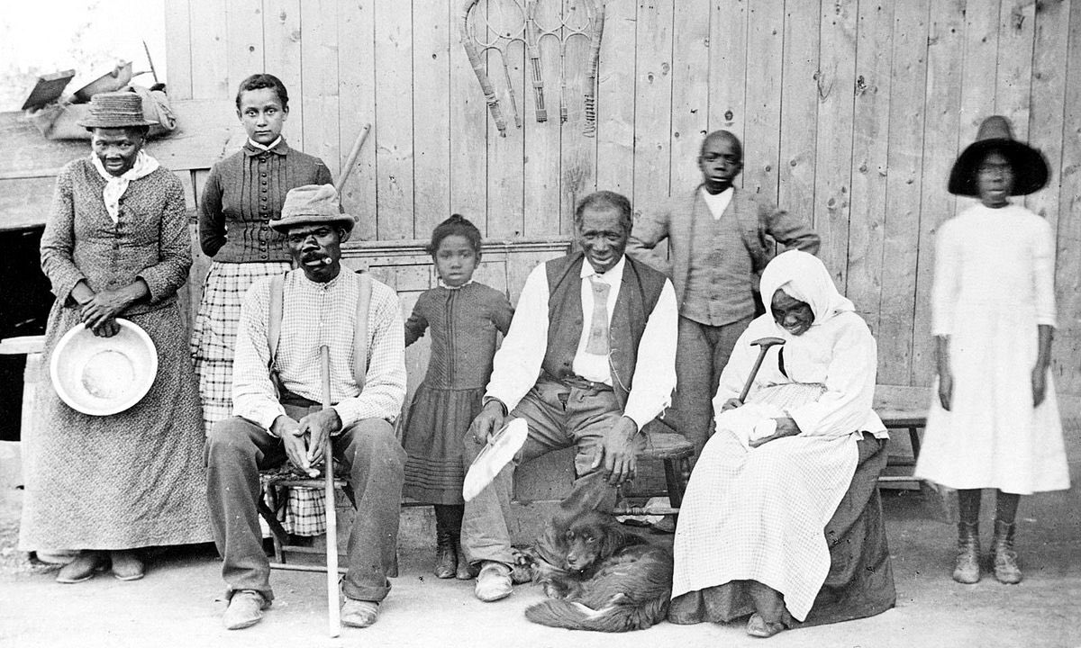 Harriet Tubman, far left, with family and neighbors at her home in Auburn, NY, 1887.