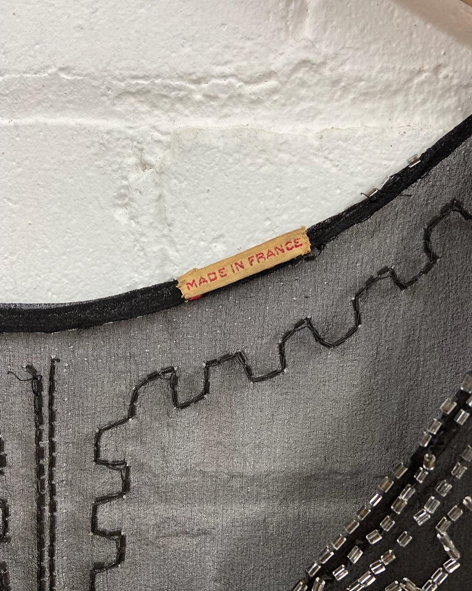Landi_company's tweet photo. Detail from a #1920s #beaded #flapperdress, still intact with its original label! #1920sfashion #conservation #textileconservation #costume #costumeconservation https://t.co/Ig4ERr5Jqj