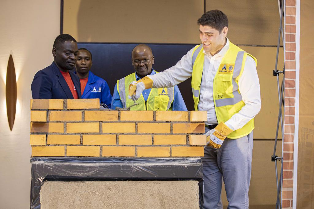 CimerwaPlc's tweet photo. And, on a semi-lighter note, our very own Murat Altun of #SummaRwanda joined our @CIMERWACEO to have a first hand try at bricklaying using our #FitForPurpose cement #Surewall https://t.co/QaroN2dTsd