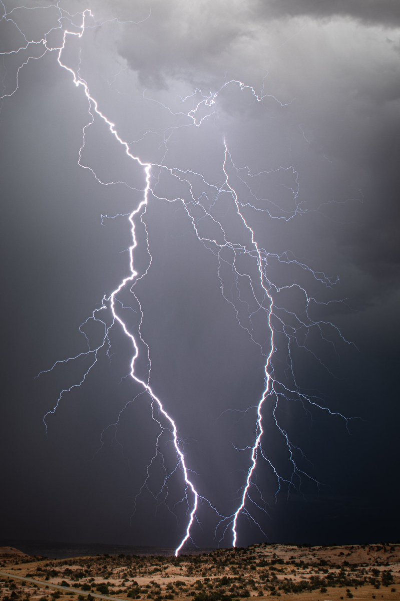 Twin bolts strike amongst the arid landscape of Moab, Utah just a mile or two away from our position. For scale, you can see the highway in the bottom left corner. ⛈