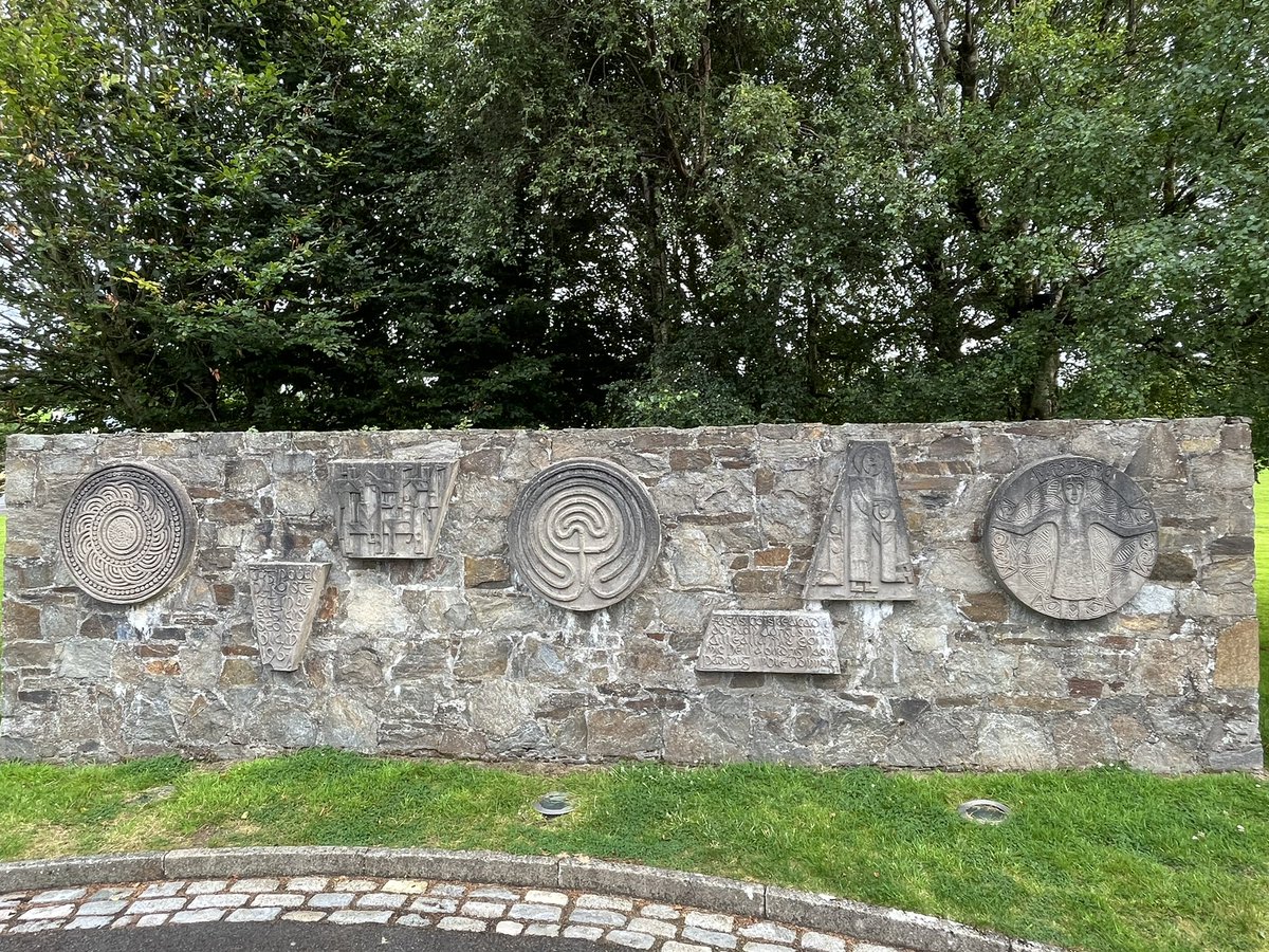DunleavyBernard's tweet photo. The fifth stop on our tour of Liam McCormick’s #MagnificentSeven Donegal churches. St Aengus at Burt - extraordinary echoing of An Grianán of Aileach in its shape, oculus altar light, Oisín Kelly reliefs, Imogen Stuart cross. #LiamMcCormick #RHA @RHAGallery @govisitdonegal https://t.co/6ErPDEDjvj