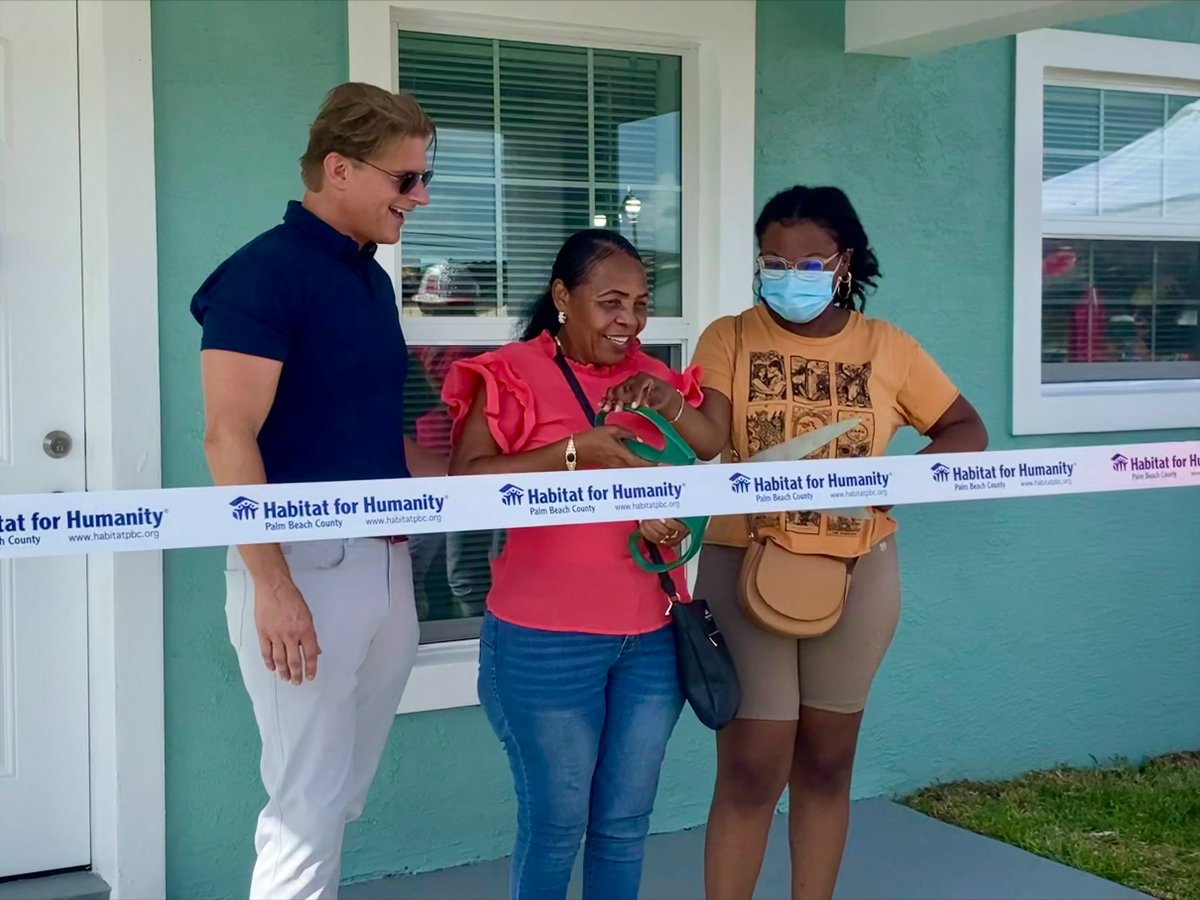 carrier's tweet photo. Chris Boccaccio, VP Legal Compliance for Carrier and @HabitatPBC board member, celebrates with the Volmard family at their key dedication ceremony. Carrier volunteers assisted with painting the interior of the home and building the fence for the lovely home. #BuildingPossible https://t.co/th6ooZ5iVQ