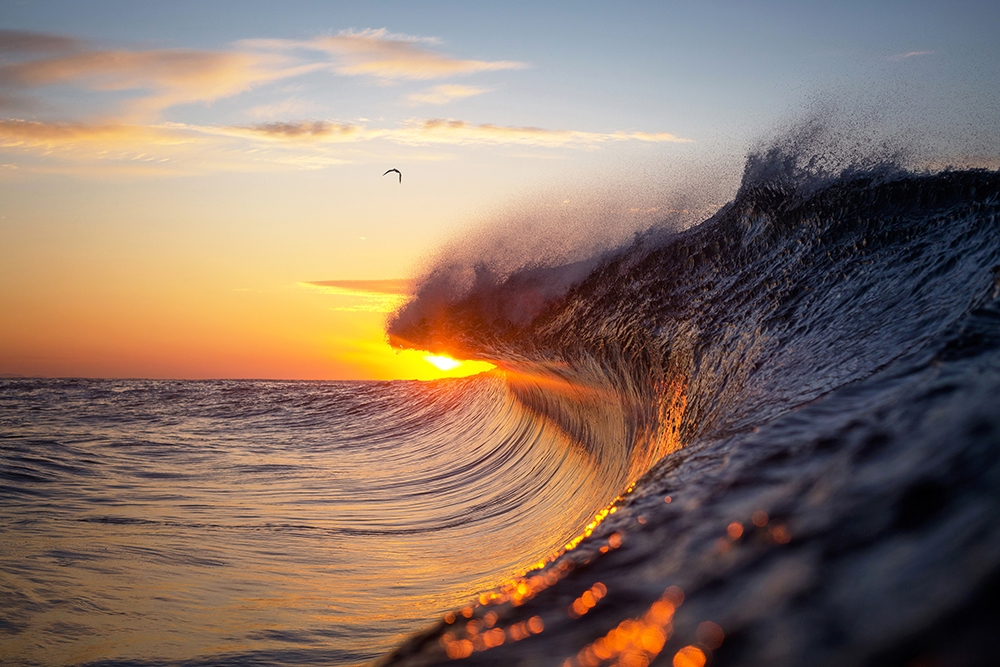 As the sun rises above the sea.