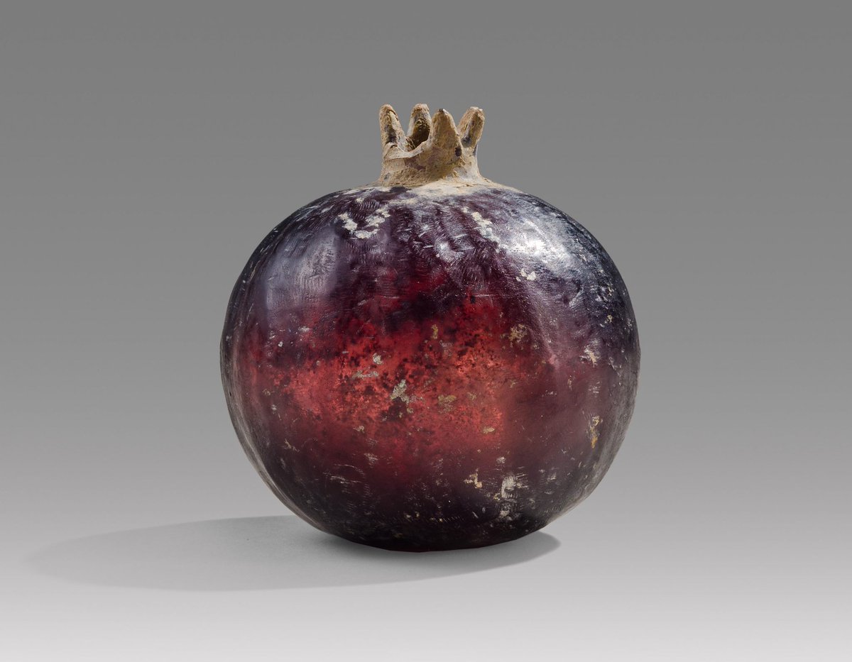 DrJEBall's tweet image. A beautiful piece of #Hellenistic/#Roman-period glass in the shape of a pomegranate. The glass is wonderfully preserved, &amp;amp; the colours are stunning. It was likely once used to hold perfume, &amp;amp; may have been put in a grave as an offering to the dead (📷 Phoenix Ancient Art)