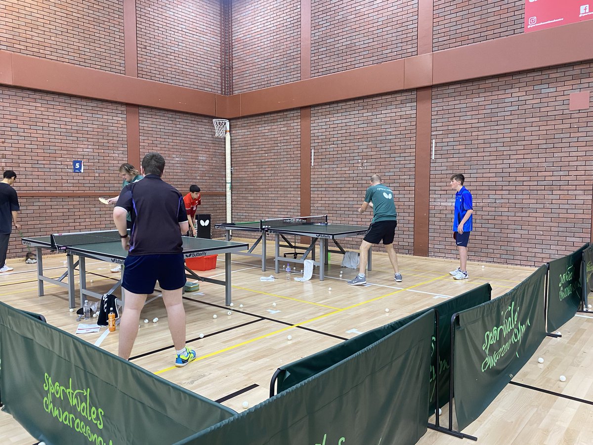 walesTT's tweet photo. Another great day of Table tennis over 🏓. A full hall and lots of hard work.  Looking at 3rd ball this morning and Tactics and variation this afternoon. Well done to Ben our player of the day.  Bring on the Crazy Golf ⛳️ tonight https://t.co/VN5FdPf6J3