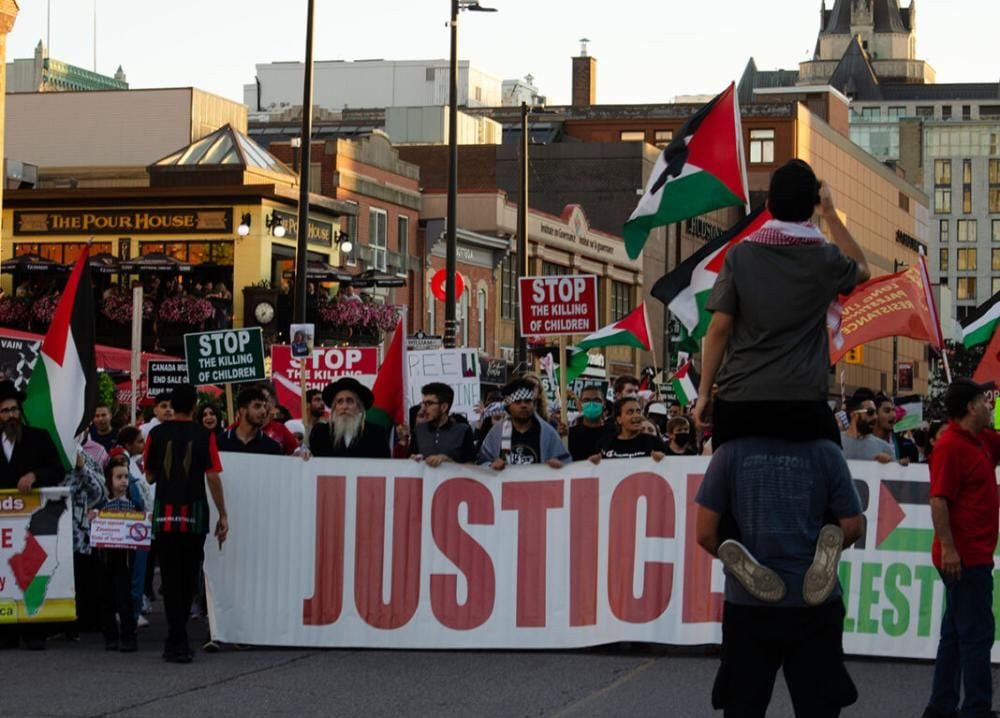 SaraReyi's tweet photo. Hundreds of protesters gathered at the Human Rights Monument in Canada to demand the Canadian government hold isr*el accountable for recent airstrikes on Gaza. https://t.co/YnF9GBhGFP