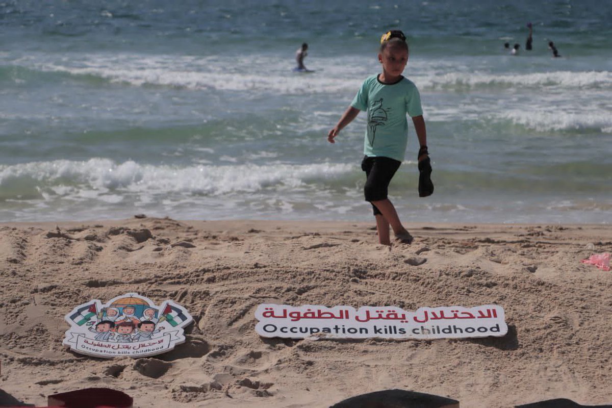 Timesofgaza's tweet photo. Palestinians in Gaza honour the children who were killed in the recent lsraeli aggression on the Gaza Strip by creating a sand sculpture showing their names. https://t.co/pLu9grGNzI
