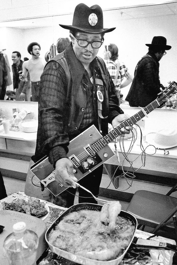 Bo Diddley frying chicken in his dressing room before a concert, 1972. 
Photo by ©Don Paulsen