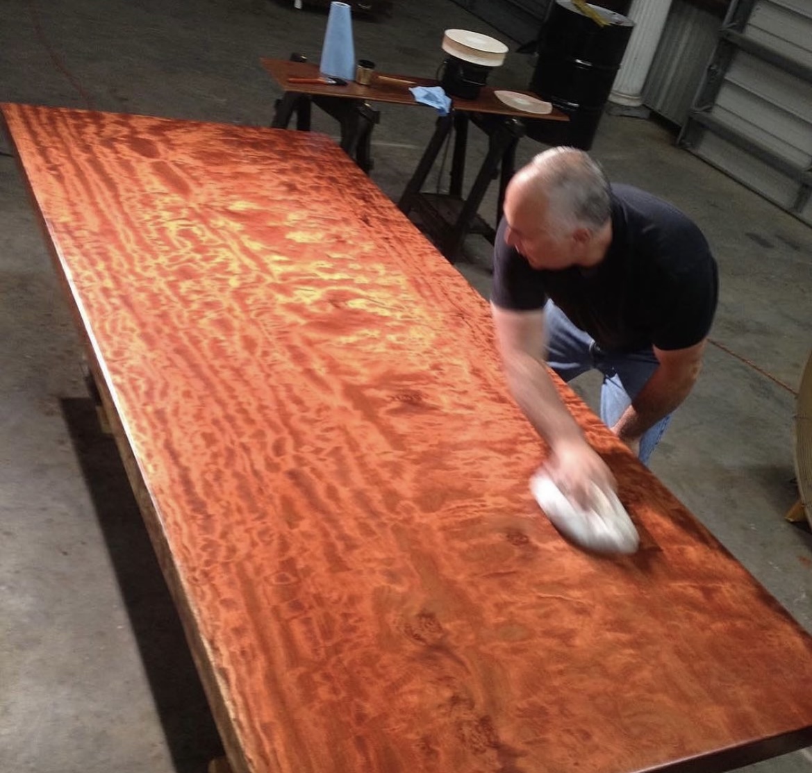 OdiesOil's tweet photo. Our founder, James, buffs off Odie’s on a bubinga single slab table! #odiesoil #naturalproduct #safeproduct #woodworking #buffing #buffoff https://t.co/zeKowVvluJ