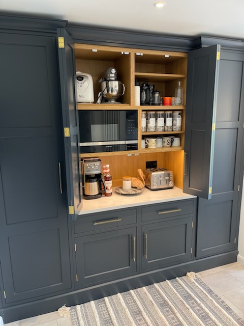 Bespoke pantry painted in Farrow and Ball Railings with Corian worktop. Handles are by Foundry. #bespokekitchen #bespokepantry #johnladbury #bluekitchen #Corian #Foundry #newkitchen #kitchenideas #Hertskitchen #kitchenideas #kitchendesign