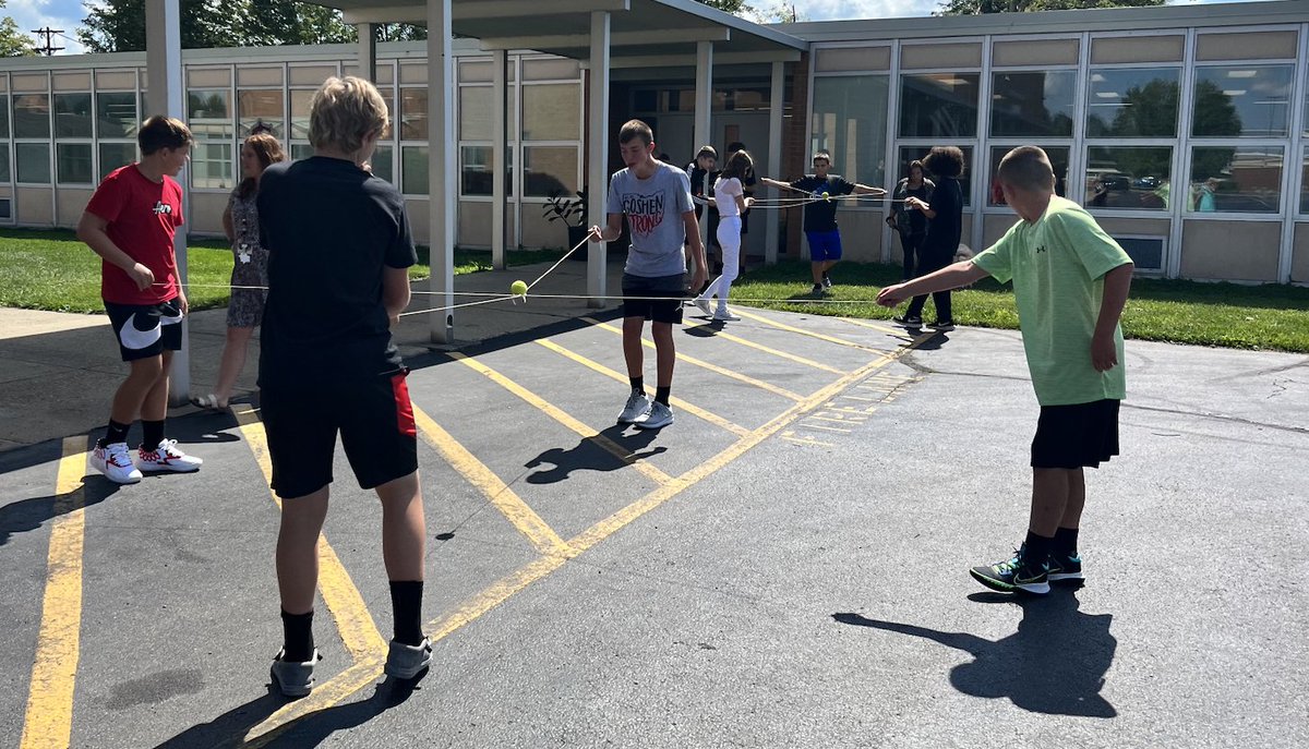 gmswarrior's tweet photo. At GMS, students use their collaboration skills to work together on a team building challenge in Mrs. DeNu’s class today! They had to move a tennis ball across the yard without dropping it on a ring holding only strings. https://t.co/JNuW6nqnAP