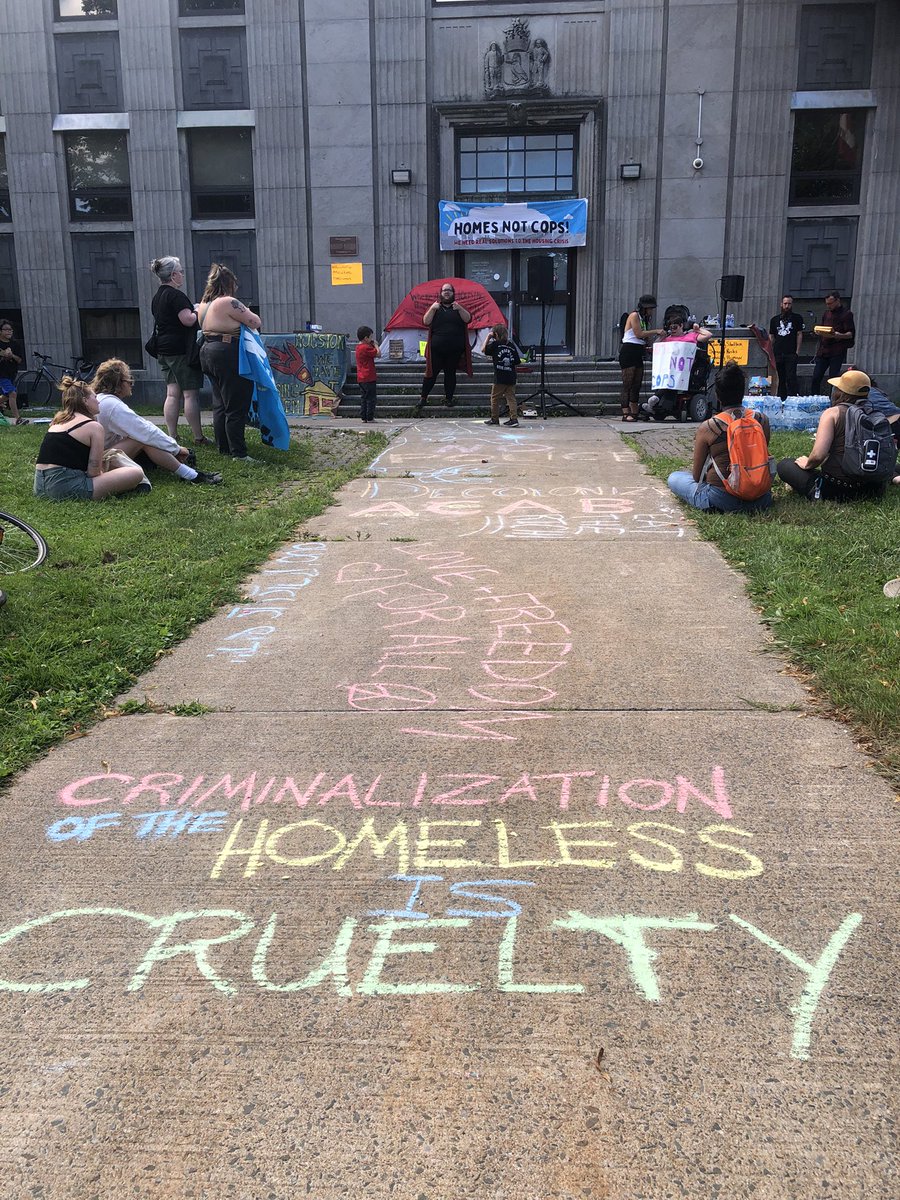 PADScommunity's tweet photo. Hundreds are gathered at the Old Memorial Library in Halifax on the anniversary of the brutal evictions of homeless encampments that in part took place here. We are here to demand #HomesNotCops &amp; #HousingForAll https://t.co/BEb9DSsZJb