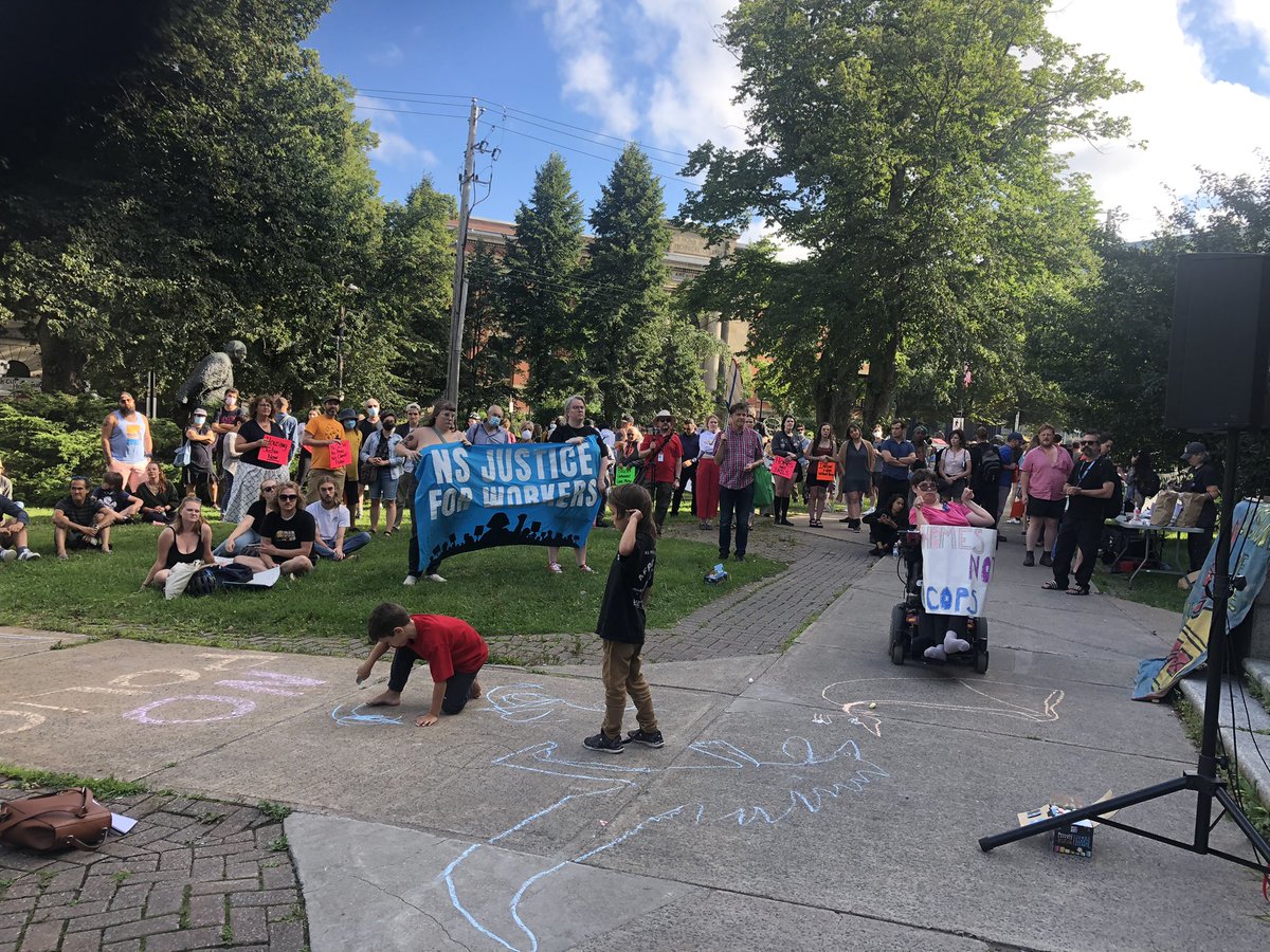PADScommunity's tweet photo. Hundreds are gathered at the Old Memorial Library in Halifax on the anniversary of the brutal evictions of homeless encampments that in part took place here. We are here to demand #HomesNotCops &amp; #HousingForAll https://t.co/BEb9DSsZJb