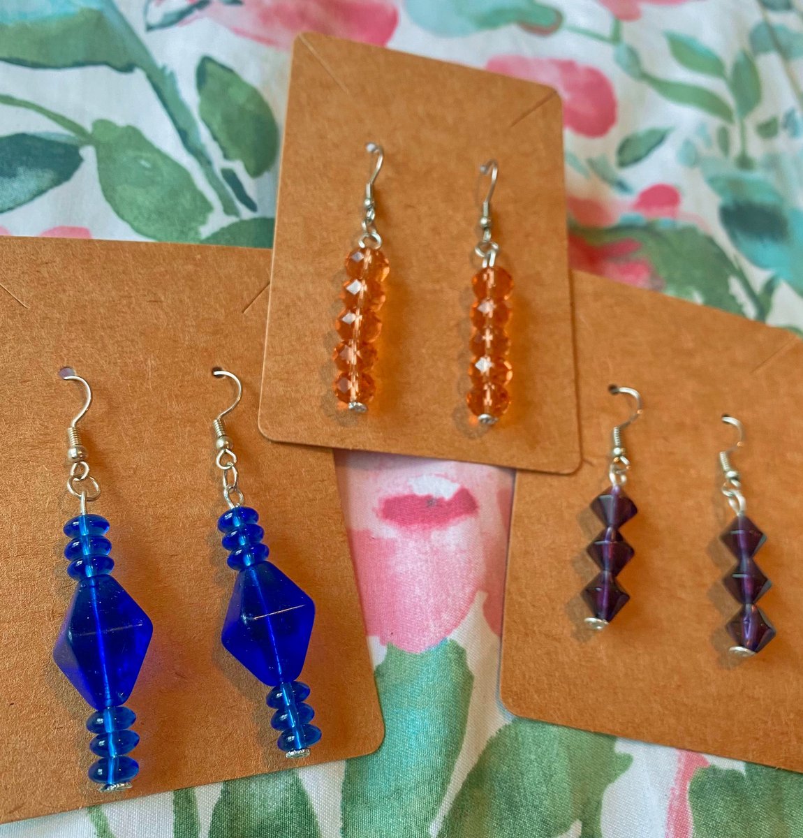 $8 earrings available! 🧡💙💜