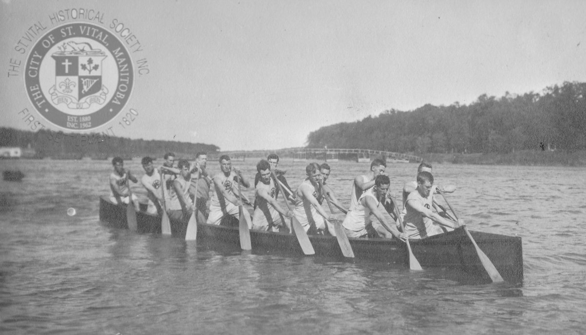Members of the Wpg Canoe Club paddle along the Red River, c.1910s. The Elm Park pontoon bridge can be seen behind. One of these men was John McVicar, who lived at the corner of Kingston Row &amp; Dunkirk Place, St. Vital. #stvitalmuseum #stvital #museum #archives #winnipeg #manitoba