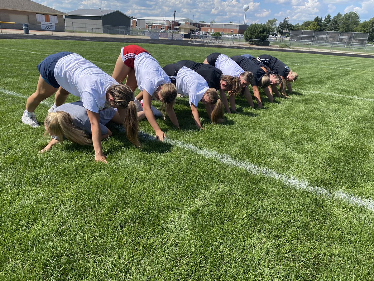 Varsity Volleyball working on the football field with some team building.