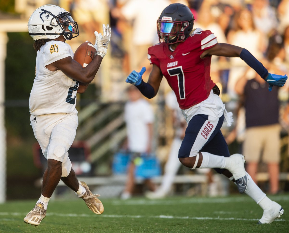 St. James' KJ Jackson (1) comes out swinging with an 80-yard touchdown connection with Ethan Beard (2) on the first down of the game. St. James leads Montgomery Academy 35-7 at halftime.