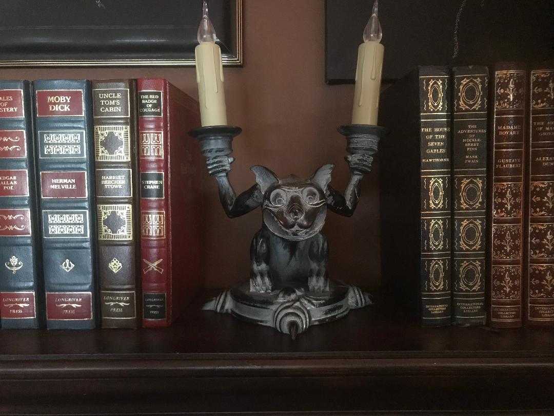 24framespod's tweet photo. @testpatternshow I need a fellow monster kid's opinion. What should go on the bookshelf; the Poe bust or the Haunted Mansion gargoyle? https://t.co/5YUBg0vIEC