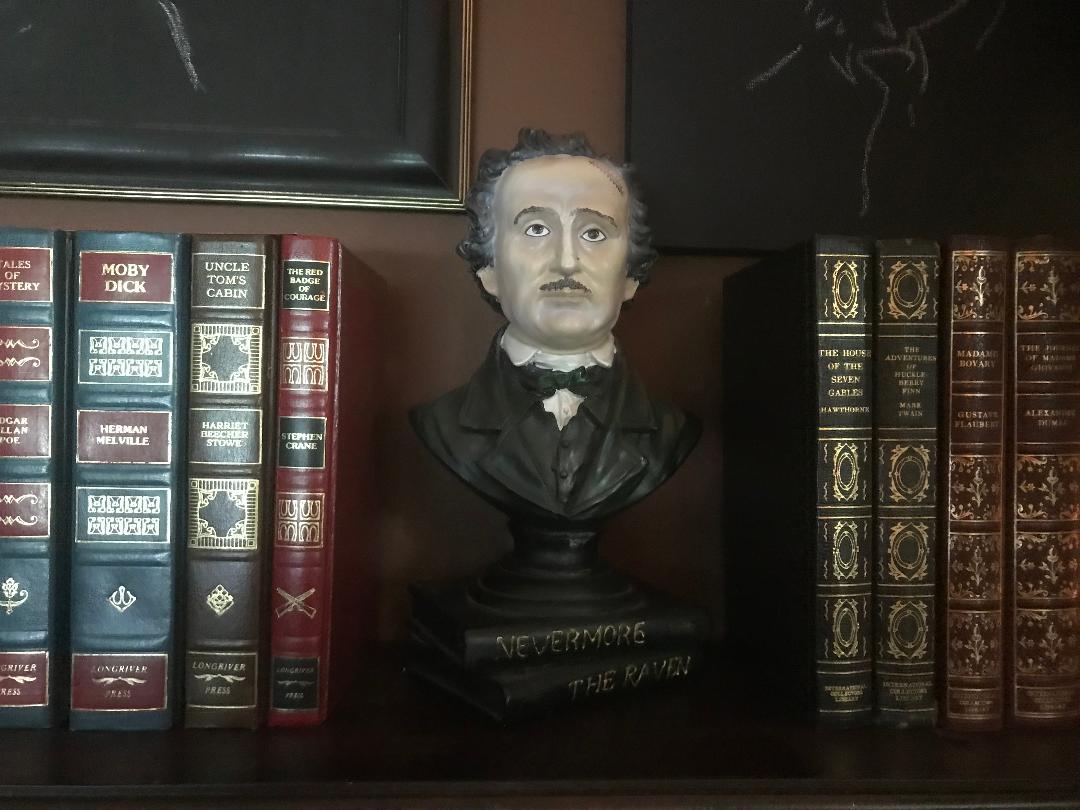24framespod's tweet photo. @testpatternshow I need a fellow monster kid's opinion. What should go on the bookshelf; the Poe bust or the Haunted Mansion gargoyle? https://t.co/5YUBg0vIEC