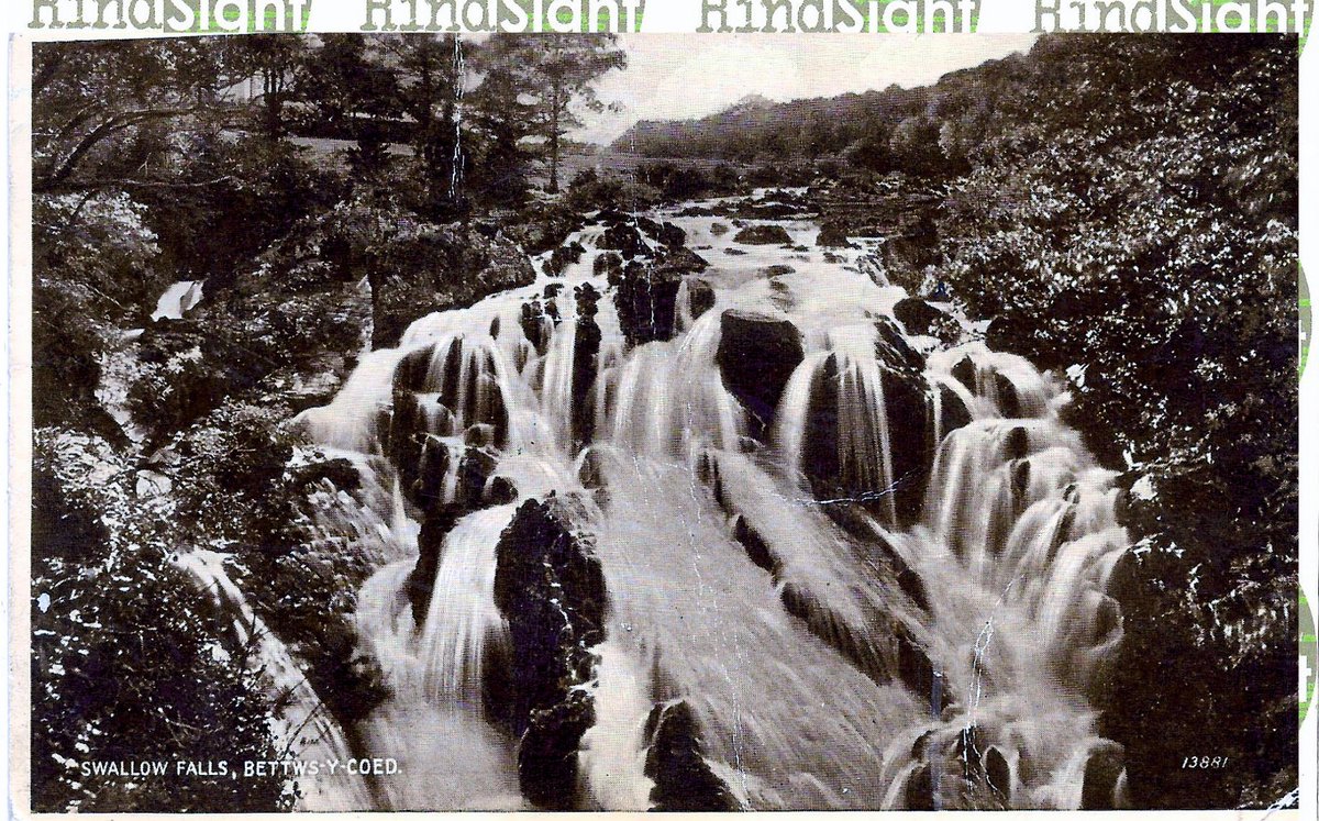 1920Hindsight's tweet photo. Swallow Falls, Betws Y Coed, Wales. From 1953. A thundery night, but sender seems happy with the car. #1920Hindsight #SwallowFalls #BetwsYCoes https://t.co/aMT2VFku2b