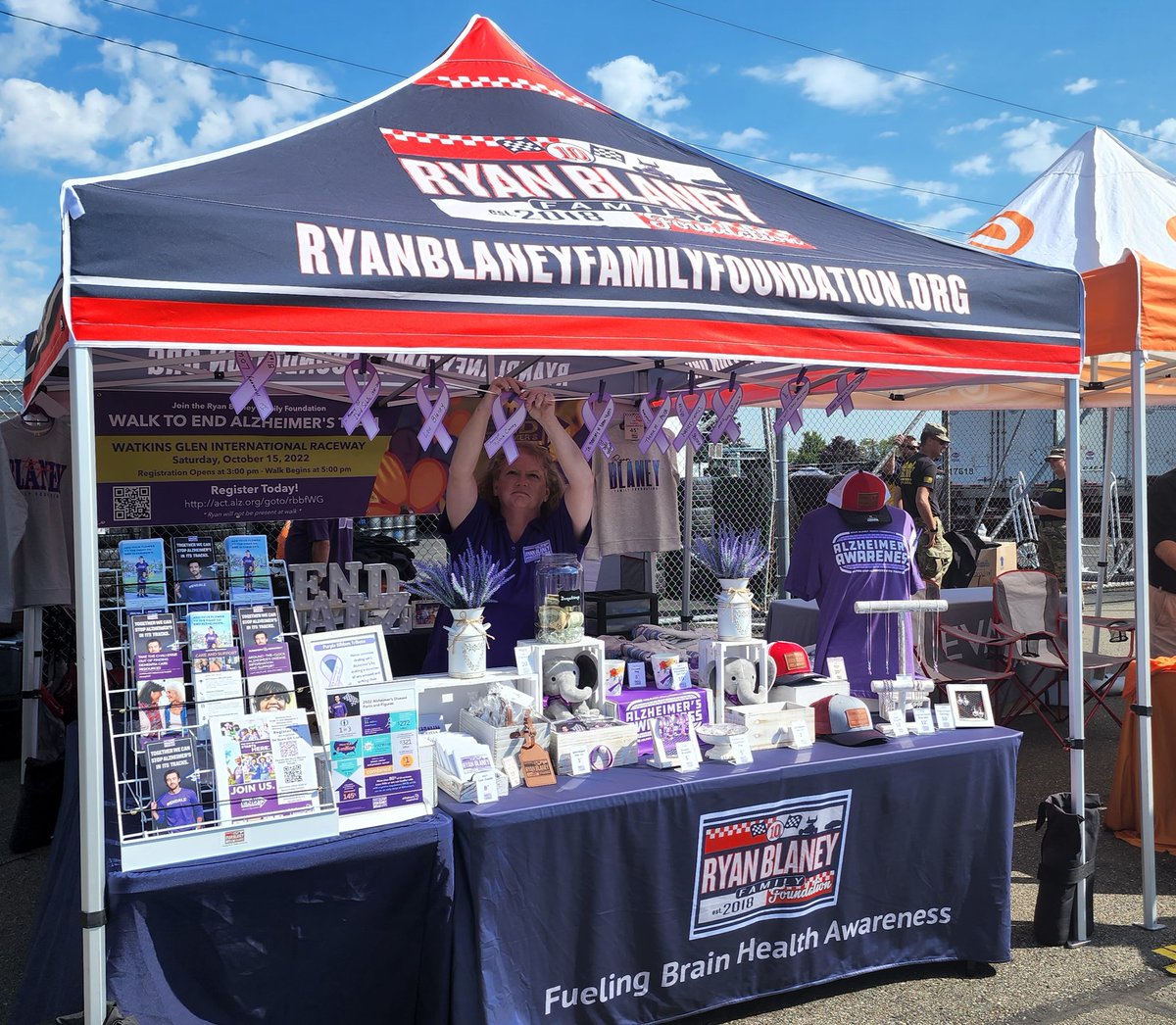 rbfamfoundation's tweet photo. We are hanging up ribbons in honor of those affected by #Alzheimers at our booth at @wgi1948 💜 Come by and see us today in the Midway until 3 pm. We have great info, merch, and smiles! 😁 #dementia #NASCAR #brainhealth #rbff #saturday https://t.co/cIoOzW2Cl3