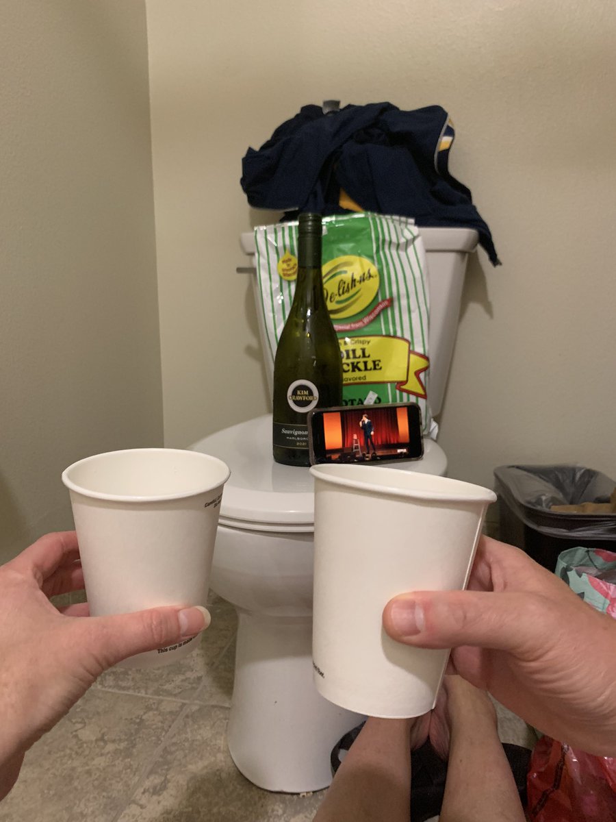 JosephDorn's tweet photo. At a wedding instead of going to see @mulaney in #Milwaukee @FiservForum. A sleeping toddler “forced” my wife and I to use the bathroom as a hangout spot, so we decided to watch some stand up while crushing some @kimcrawfordwine and chips. #AndWithYourSpirit #BestDinnerEver https://t.co/MD3OzG1IFW