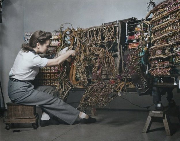 1958. an engineer wiring an IBM computer