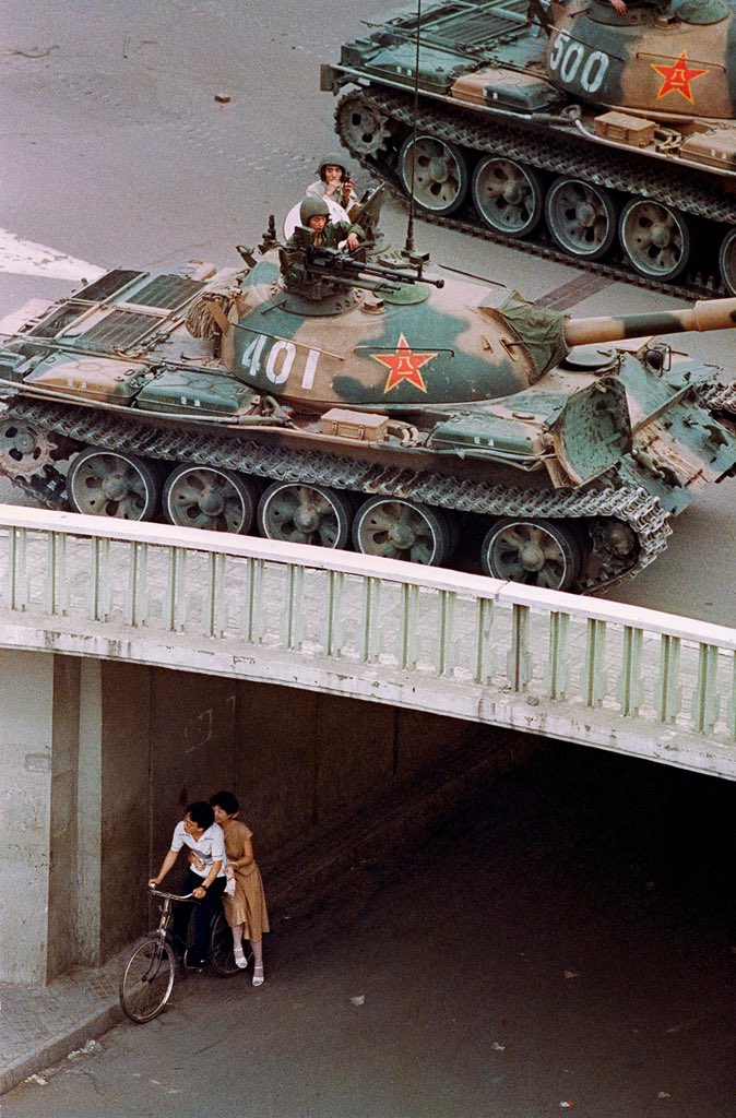 A young couple on a bicycle hide from Chinese soldiers in a tank overhead during the Tiananmen Square protests that were crushed June 4, 1989. Liu Heung Shing
Street Photographers Foundation