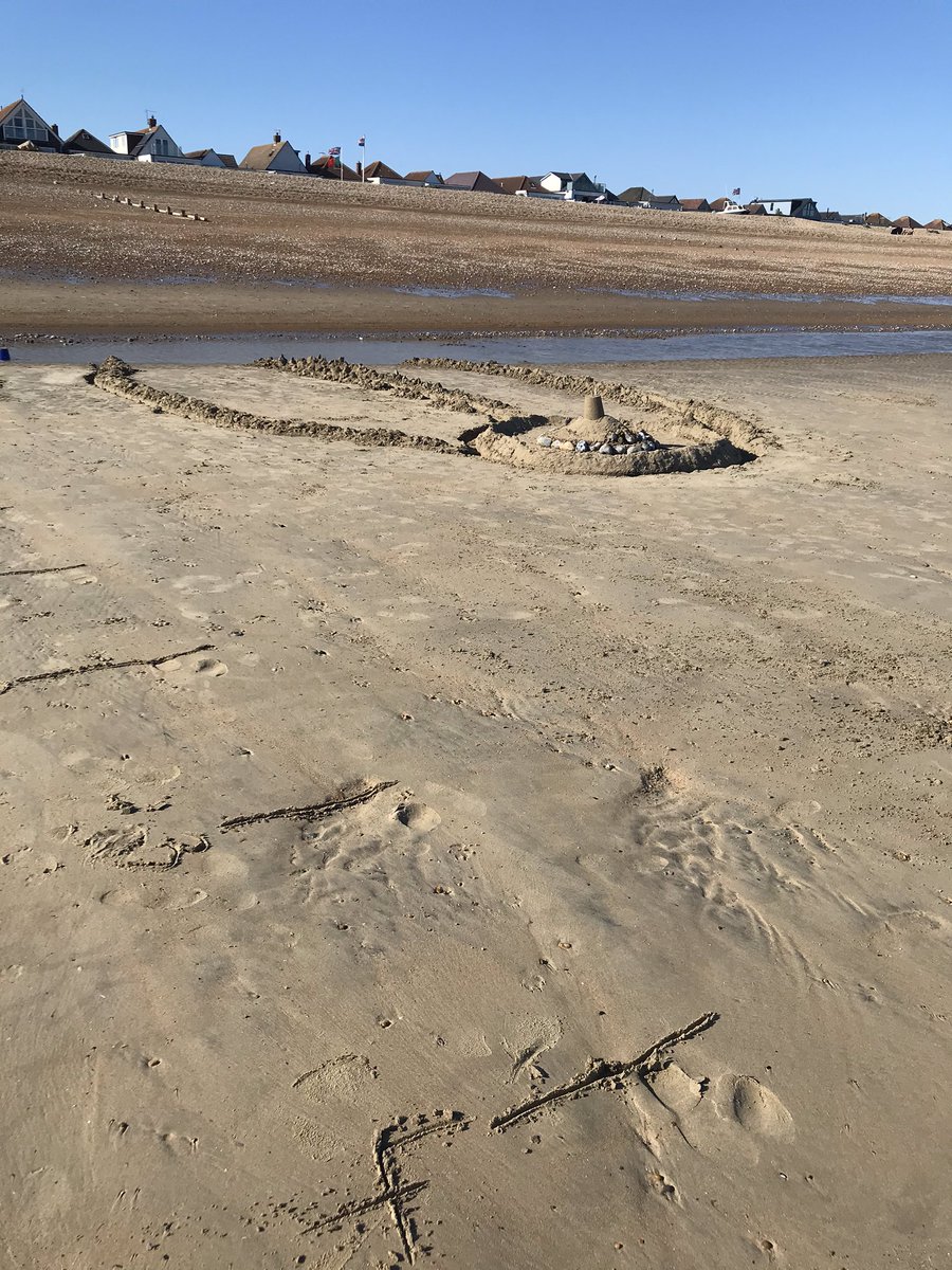 RebeccaTurvill's tweet photo. Drawing a numberline in the sand to measure how near the tide is to meet our sand castle. Then timing its destruction! #holidaymaths https://t.co/dKS21PvkGY