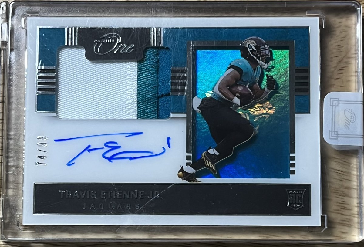 iampgmcards's tweet photo. Leaving another overnight #Giveaway with an absolute beauty of a card. All you need to do is RT this message and go follow @ IamPGMCards on Instagram. I will be selecting a winner tomorrow to take home this Travis Etienne Panini One Shadow Box RPA /99! #IamPGMCards #Etienne https://t.co/uJsgH0ZDcP