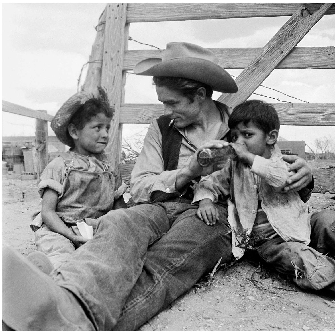 TracesofTexas's tweet photo. James Dean shares a Coca Cola with kids from Marfa while on the set of "Giant,"  1955. https://t.co/nW397Rjyit