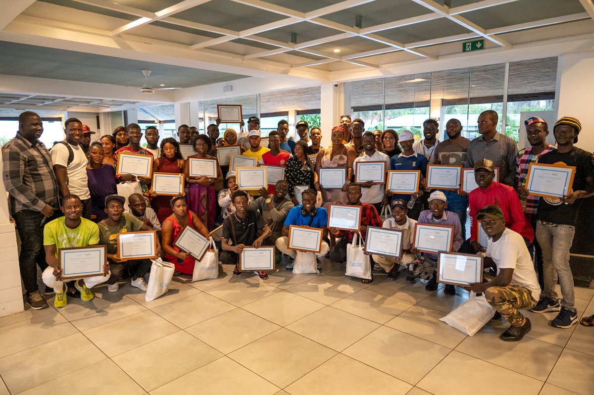 IOMTheGambia's tweet photo. As we wrap up our @MigrantsM Project in The Gambia, we conducted a final monthly meeting to recognize the hard work and dedication of our #MaMVolunteers. They received visibility items to support their continued efforts to raise awareness about irregular migration. https://t.co/C0kacwIP92