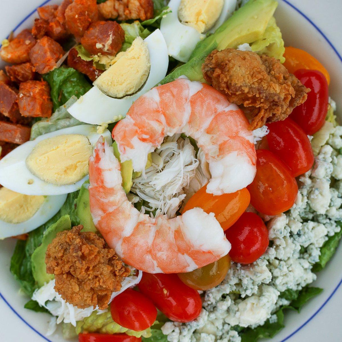 Seafood. It's what we do ~ The Eastern Shore Cobb Salad
.
Sugarcured Ham • Jumbo Lump Crab • Fried Oysters • Avocado • Grilled Corn Bleu Cheese • Tomato • Hard Boiled Egg • Champagne Vinaigrette