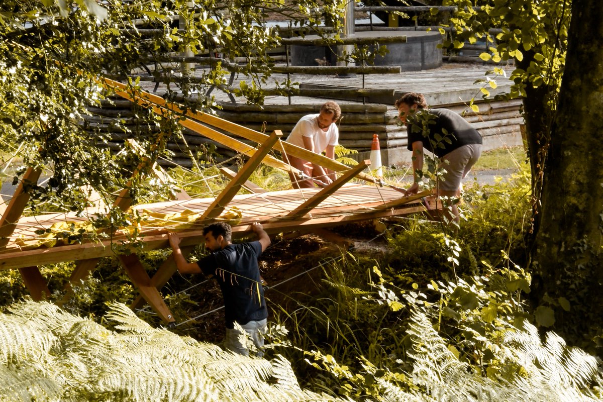 HookePark's tweet photo. @ArupGroup  was onsite at @HookePark fabricating and installing a replacement footbridge connecting the workshop and refectory. The structure is built of local site-milled western red cedar and held in tension through a series of lovely steel cable connections.

#designbuild https://t.co/GvbibNzGB2